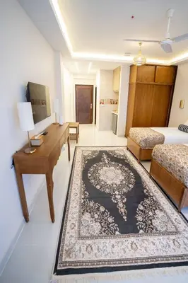 a living room with a bed and a rug at Theban Hills Hotel, Luxor in ‘Ezbet Abu Ḥabashi