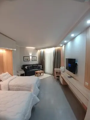 a hotel room with two beds and a living room at فندق ومنتجع سكاندك in Hurghada