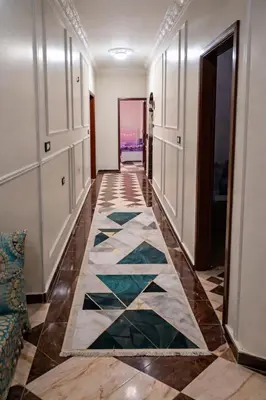 a hallway with a tile floor in a hotel room at المحكمة in Aswan
