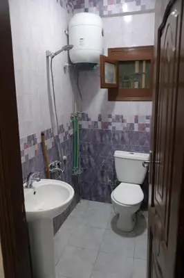 a bathroom with a toilet and a sink at المحكمة in Aswan
