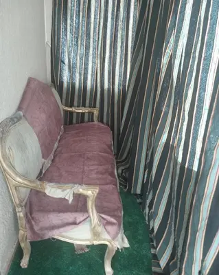 a small room with a chair and a curtain at شقة سكنية كبيرة in Aswan