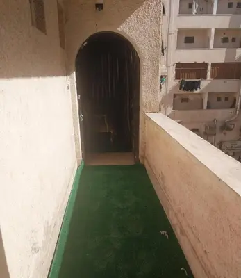 a hallway with a green floor in a building at شقة سكنية كبيرة in Aswan