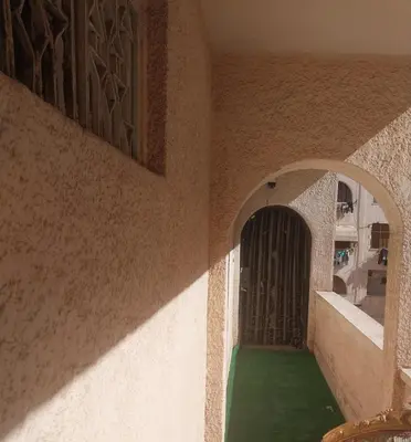 a hallway of a house with a green floor and a door at شقة سكنية كبيرة in Aswan