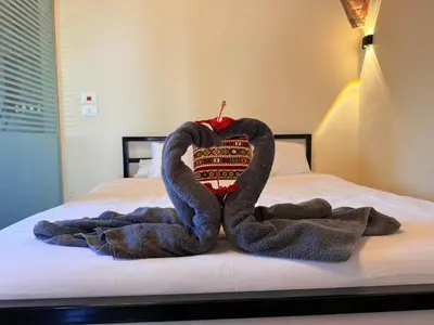 a pair of towel animals sitting on a bed at Citadel Luxor in Luxor