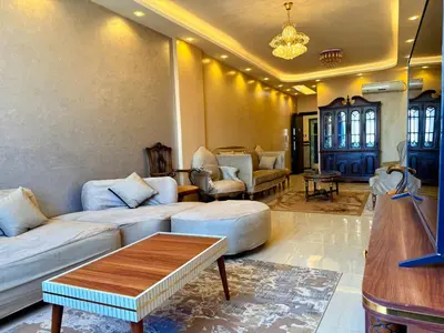 a living room with couches and a coffee table at Sun Palace House in Luxor