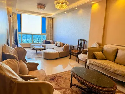 a living room with couches and chairs and a table at Sun Palace House in Luxor