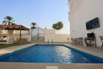 a swimming pool in the backyard of a house at White Gorf Hotel in Luxor