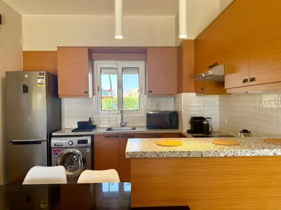 a kitchen with a stove and a dishwasher at Scenic 2BR Ground Floor - Free Pool& Lagoon Access In ElGouna in Hurghada