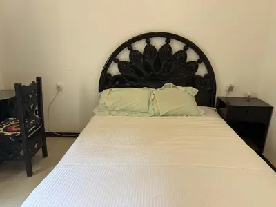 a bed with a large headboard in a room at Ramla Palace House in Luxor