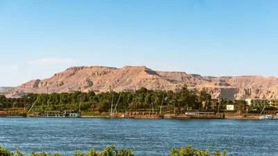 a large body of water with mountains in the background at Ramla Palace House in Luxor