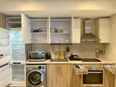a kitchen with a sink and a washing machine at Cozy 2BR Plus Nanny - Free Beach&Pool In Mangroovy ElGouna in Hurghada