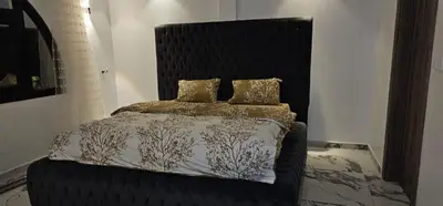 a bed with a black headboard in a room at ROOF TOP 12 Seaview in Hurghada