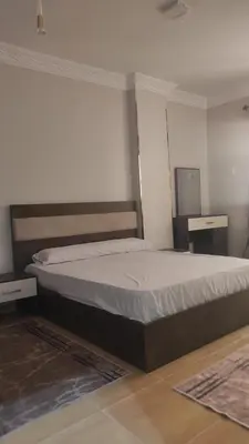 a bedroom with a bed and two night stands at Nice flat in region Intercontinental in Hurghada
