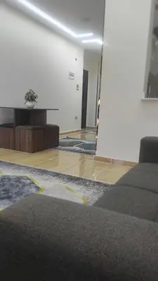 a living room with a bed and a room with a table at Nice flat in region Intercontinental in Hurghada