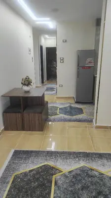 a living room with a refrigerator and some rugs at Nice flat in region Intercontinental in Hurghada