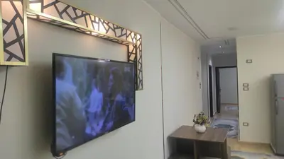 a flat screen tv hanging on a wall at Nice flat in region Intercontinental in Hurghada