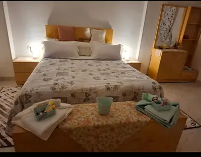 a bedroom with a bed with two towels on a table at Villa Azad Elkber in Quseir