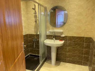 a bathroom with a sink and a shower with a mirror at مصر in Hurghada