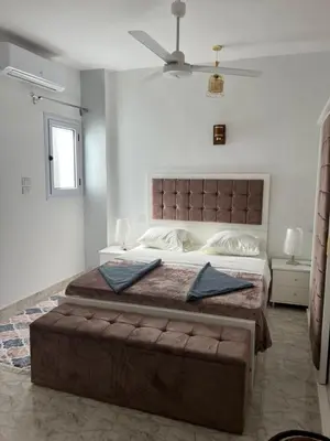 a bedroom with a large bed with two pillows on it at Orange guest house in Luxor