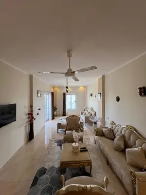 a living room with couches and a table at Orange guest house in Luxor