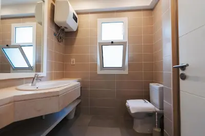 a bathroom with a sink and a toilet at Joubal 2BR Lagoon View Residence in Hurghada