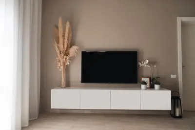 a living room with a tv on a white cabinet at Spacious Lagoon View Villa At Joubal in Hurghada
