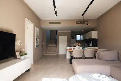 a living room with a couch and a dining room at Spacious Lagoon View Villa At Joubal in Hurghada