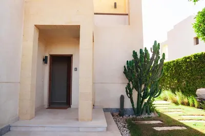 a building with a door and a cactus in front of it at Spacious Lagoon View Villa At Joubal in Hurghada