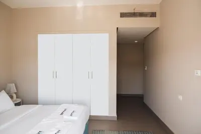 a bedroom with two beds and a large window at Spacious Lagoon View Villa At Joubal in Hurghada