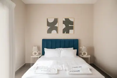 a bed with a blue headboard in a bedroom at Spacious Lagoon View Villa At Joubal in Hurghada