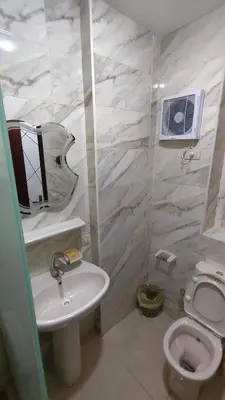 a white bathroom with a sink and a toilet at Holiday appartment in Tiba Golden in Hurghada