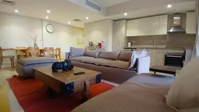 a living room with a couch and a table at Mangroovy -2BR GF Hacienda House Pool & Beach access in Hurghada