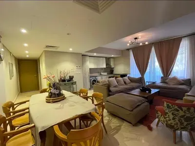 a living room with a couch and a table and chairs at Mangroovy -2BR GF Hacienda House Pool & Beach access in Hurghada