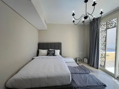 a bedroom with two beds and a large window at Mangroovy -2BR GF Hacienda House Pool & Beach access in Hurghada