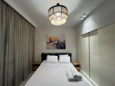 a bedroom with a bed and a chandelier at Ancient Hill 3BR Roof & Private Mini Pool in Hurghada