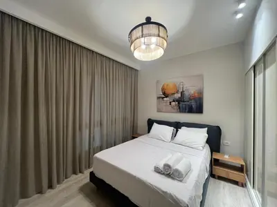 a bedroom with a bed and a chandelier at Ancient Hill 3BR Roof & Private Mini Pool in Hurghada
