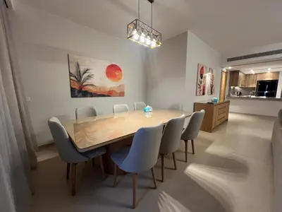 a dining room with a wooden table and chairs at Ancient Hill 3BR Roof & Private Mini Pool in Hurghada