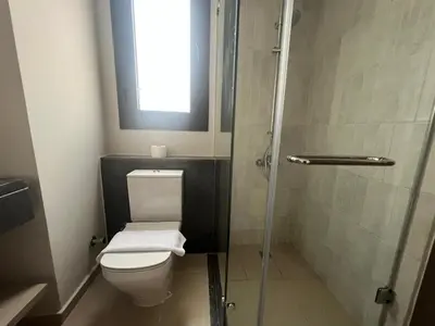 a bathroom with a toilet and a glass shower at Ancient Hill 3BR Roof & Private Mini Pool in Hurghada