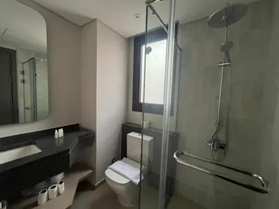 a bathroom with a toilet and a glass shower at Ancient Hill 3BR Roof & Private Mini Pool in Hurghada