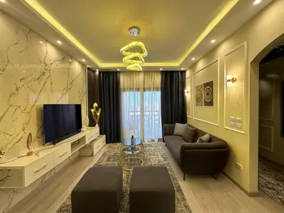 a living room with a couch and a television at Luxury apartment- Sahl Hasheesh- Gravity Hotel in Hurghada
