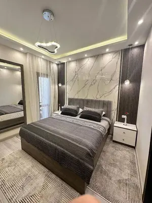 a bedroom with a large bed and a large mirror at Luxury apartment- Sahl Hasheesh- Gravity Hotel in Hurghada