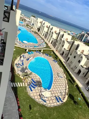 an aerial view of a resort with two swimming pools at Luxury apartment- Sahl Hasheesh- Gravity Hotel in Hurghada
