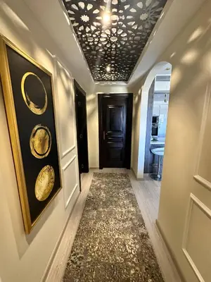 a hallway with a black door and a rug at Luxury apartment- Sahl Hasheesh- Gravity Hotel in Hurghada