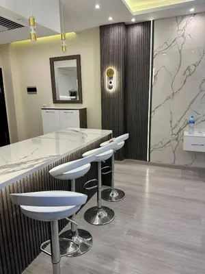 a bar with white stools in a room at Luxury apartment- Sahl Hasheesh- Gravity Hotel in Hurghada