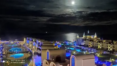 a view of a city at night with the moon at Luxury apartment- Sahl Hasheesh- Gravity Hotel in Hurghada