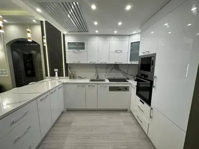 a large white kitchen with white cabinets and appliances at Luxury apartment- Sahl Hasheesh- Gravity Hotel in Hurghada