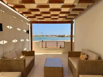 a living room with a view of the ocean at Premium 3BR Plus Nanny Villa -Free Pool And Lagoon Access In ElGouna in Hurghada
