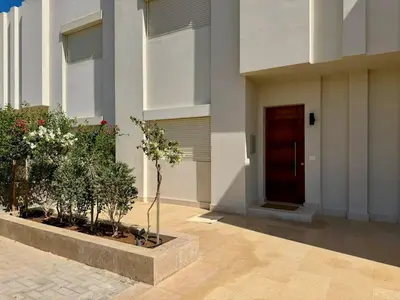 a building with a door and plants in a courtyard at Premium 3BR Plus Nanny Villa -Free Pool And Lagoon Access In ElGouna in Hurghada