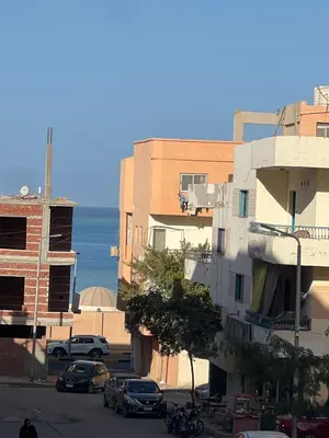 a view of a street with buildings and the ocean at Dream Apartment in Hurghada
