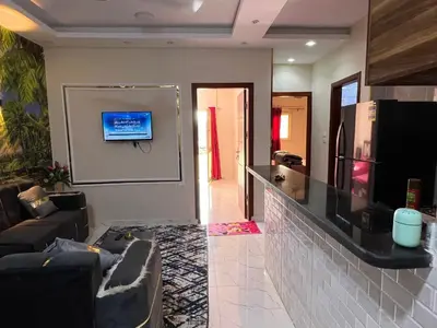 a living room with a couch and a tv on a wall at Dream Apartment in Hurghada